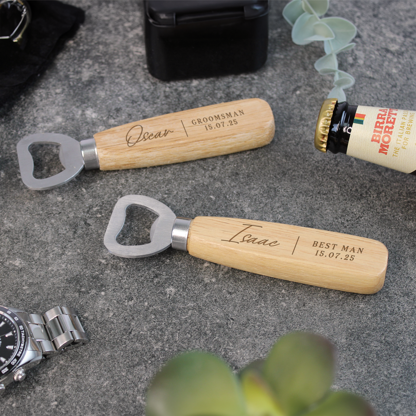 Two personalized wooden bottle openers with engraved names on a concrete surface.