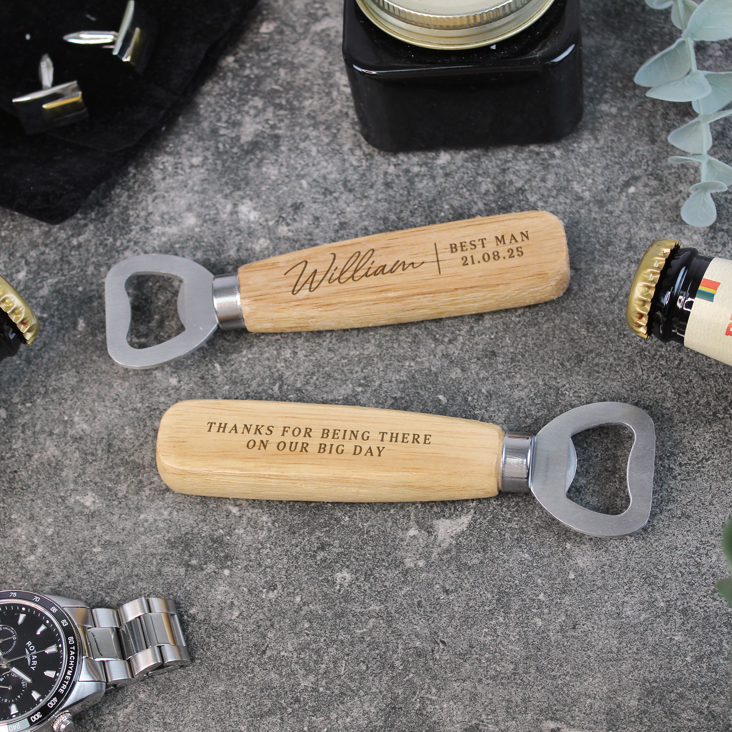 Two wooden bottle openers with engraved text on a textured surface.