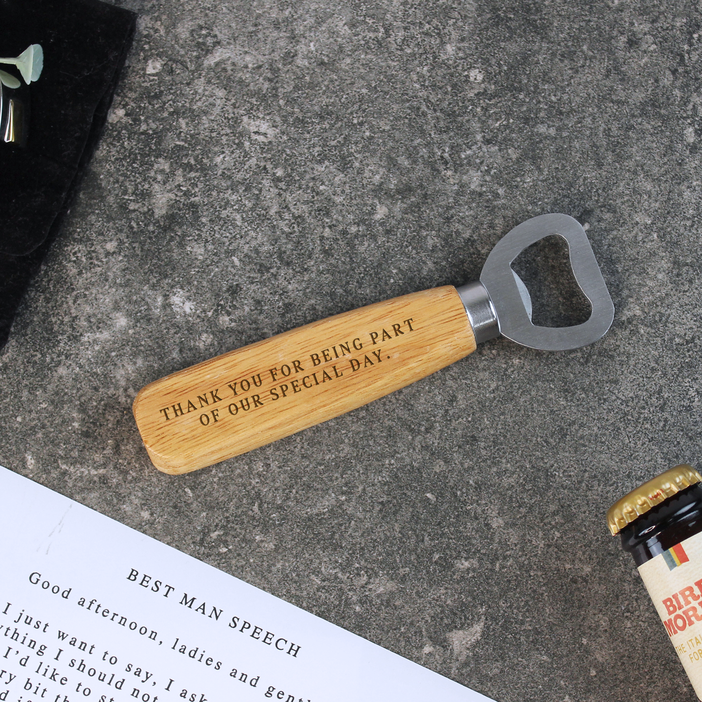 Wooden bottle opener with engraved text on a concrete surface