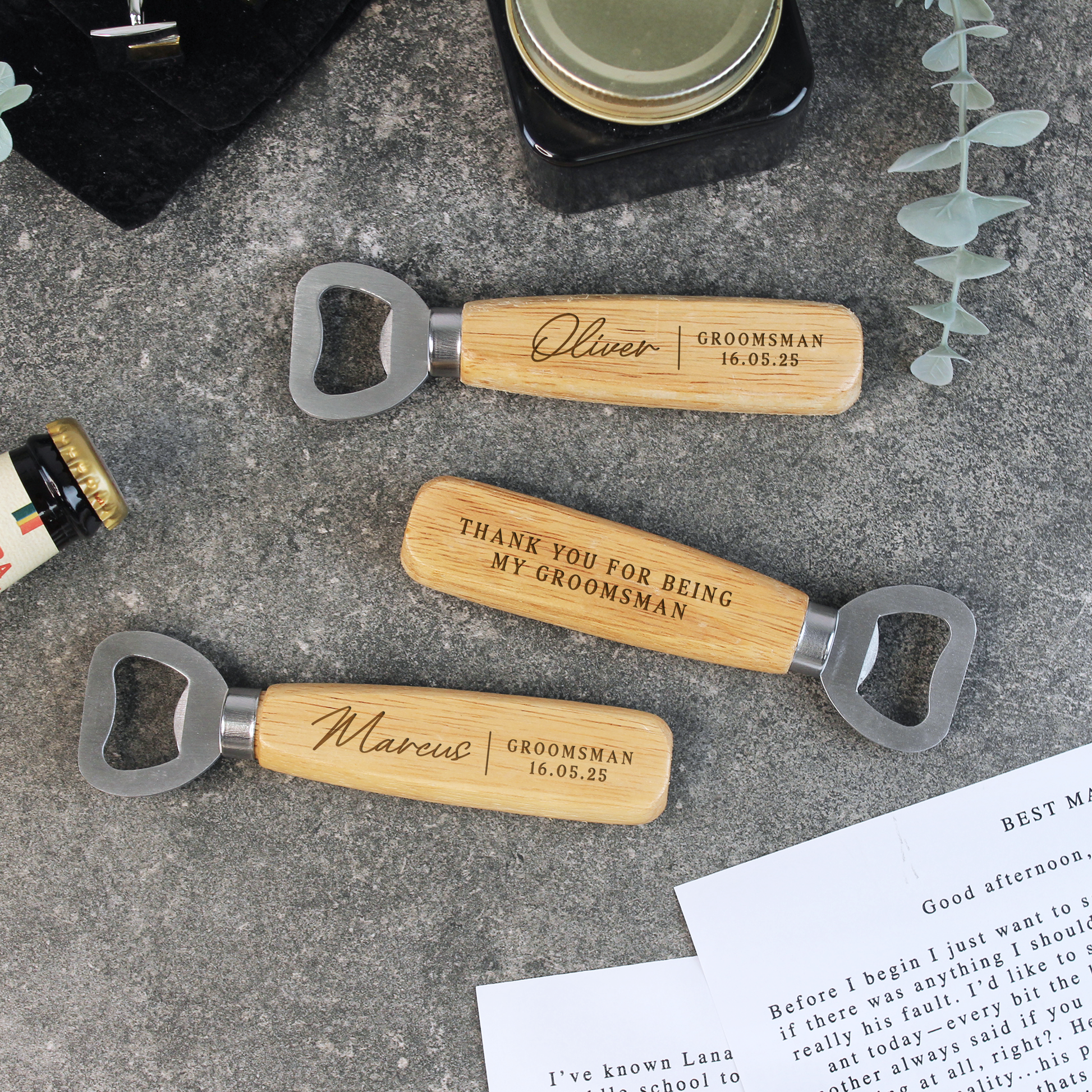 Three personalized wooden bottle openers with engraved names on a textured surface.