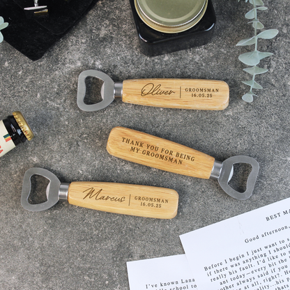Three personalized wooden bottle openers with engraved names on a textured surface.