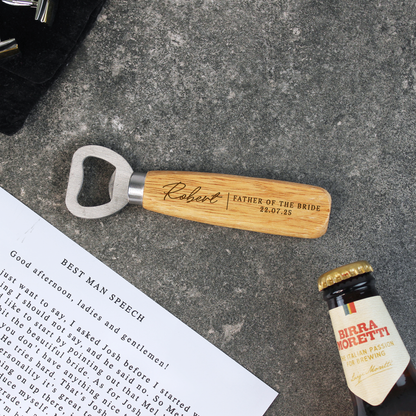 Personalized bottle opener with engraved text on a concrete surface next to a bottle of Birra Moretti.