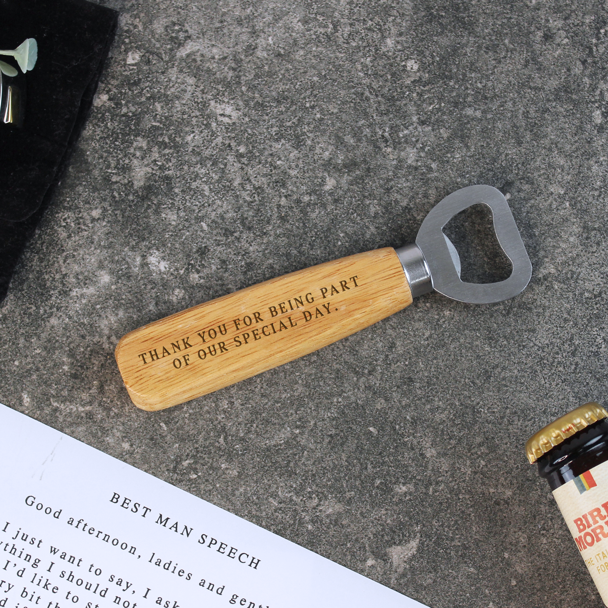Wooden bottle opener with engraved text on a concrete surface