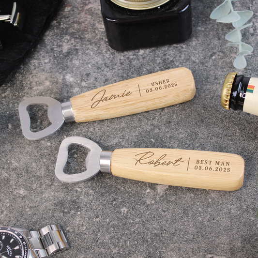 Two personalized bottle openers with engraved names on a textured surface.