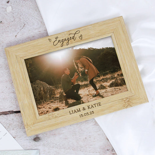 Wooden photo frame with engraved text and a couple on a romantic background