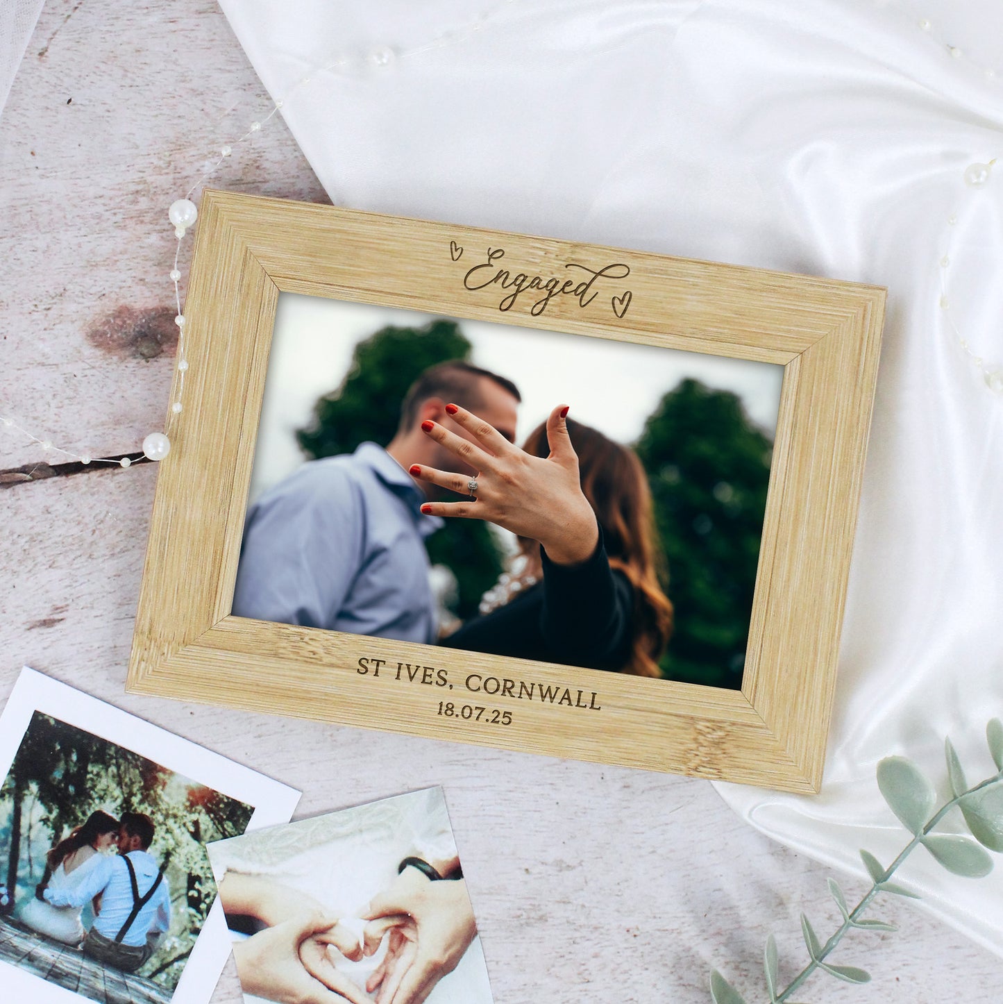 Wooden photo frame with engraved text on a light background