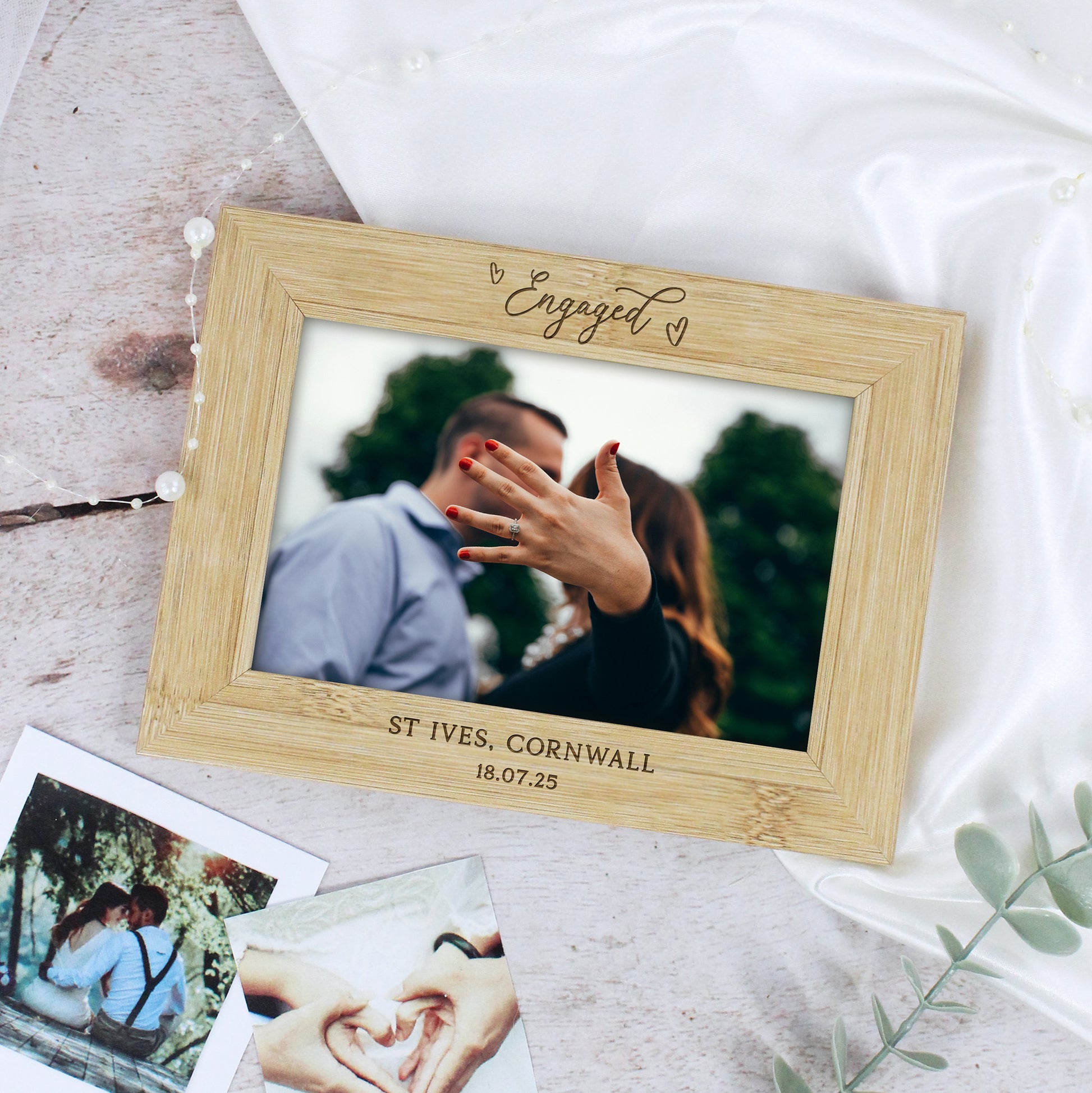 Wooden photo frame with engraved text on a light background